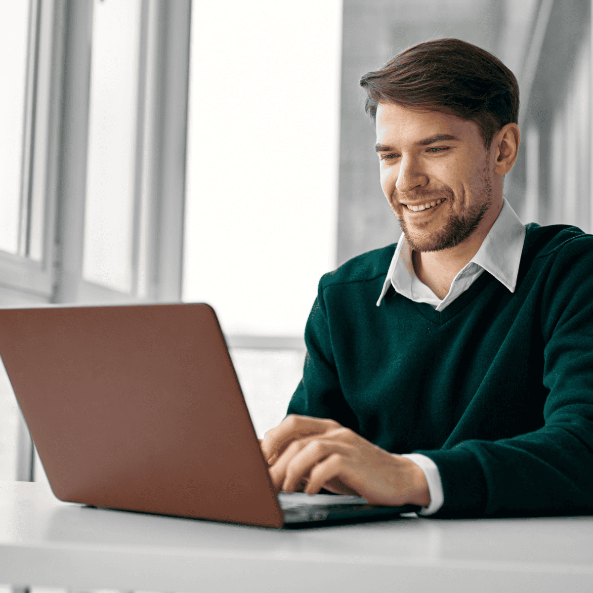 Young business owner smiling as he adds alt text to his website images